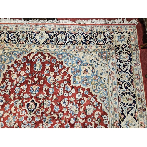 948 - A large Persian Carpet with multi borders and all over decoration with centre medallion design. 265 ... 