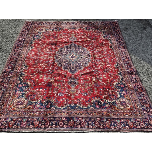 859 - A large fine hand woven Red ground Persian Kashan Carpet with a traditional Kashan design. 385 x 275... 