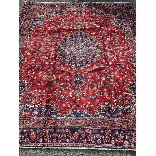 859 - A large fine hand woven Red ground Persian Kashan Carpet with a traditional Kashan design. 385 x 275... 