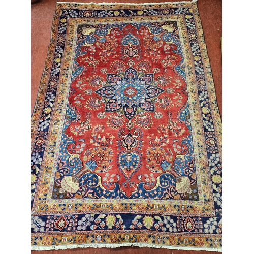 904 - A Red ground Iranian Carpet with a surrounding Blue border from the Tabriz region of Iran. 280 x 191... 