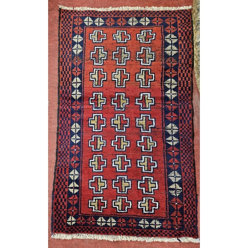 958 - A Rug red ground Afghan Belochi nomadic Rug with an all over cross design. 82 x 140 cm approx.