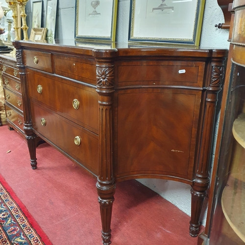 800 - A Mahogany and veneered two door Side Cabinet with twin frieze drawer and concave ends on turned flu... 