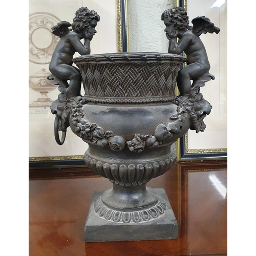 804 - A centre piece Bowl with Cherub lifting handles.
H 34 x 25 x 20 cm approx.