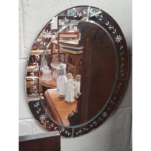 851 - A 20th Century oval Mirror with etched edging along with a birdcage candle holder and a tin.
50 x 40... 