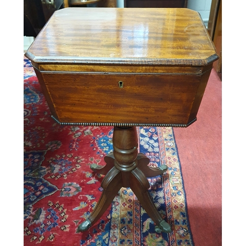 909 - A Regency Mahogany Teapoy with lined interior on quatrefoil base and brass castors and turned shaft.... 