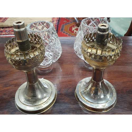 931 - An interesting pair of early 20th Century oil Lamps with later crystal Shades.