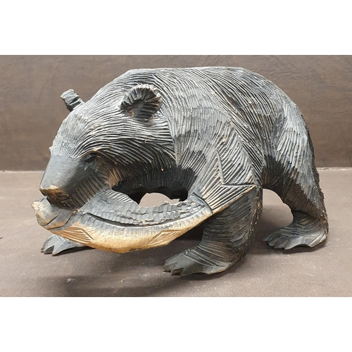 1034 - An early 20th Century Japanese carved Bear with salmon. Feet inscribed with signature. 25 x 15 cm ap... 