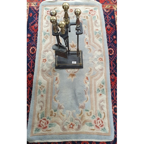 1213 - A good Metal companion Set along with an Oriental Rug. L 126 x W 62 cm approx.