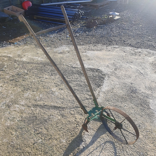 1220 - A 19th Century hand pushed furrow plough with metal head and timber handle.
L 157 cm approx.