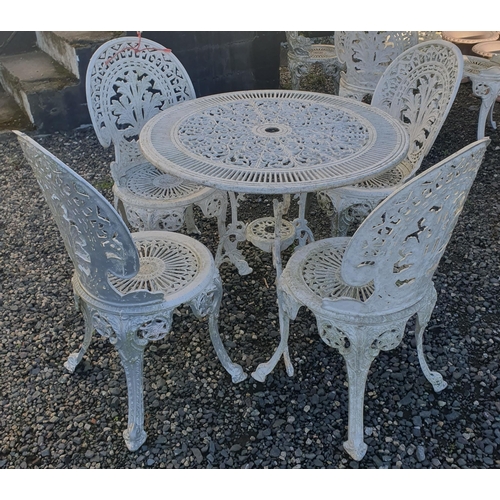 1229 - A larger Metal Patio set consisting of a circular Table and four Chairs all with pierced outline.
H ... 