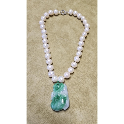 954 - A natural Pearl Necklet with a Jade Pendant.