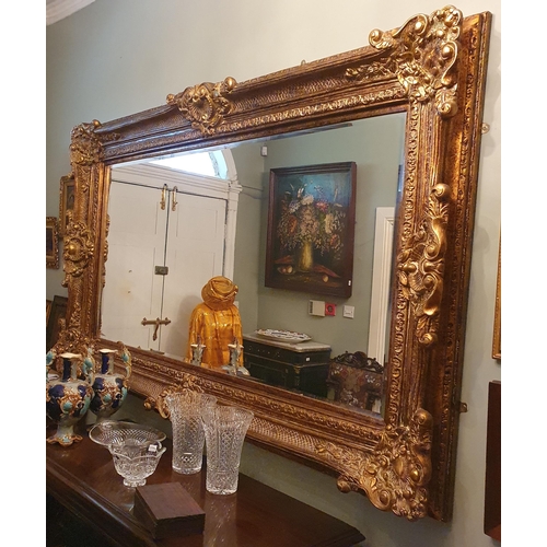 112 - An extremely large rectangular Mirror with highly carved outline and bevelled mirror glass 227 x 138... 