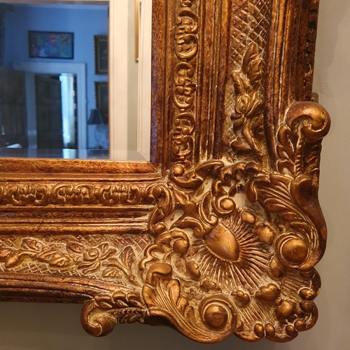 112 - An extremely large rectangular Mirror with highly carved outline and bevelled mirror glass 227 x 138... 