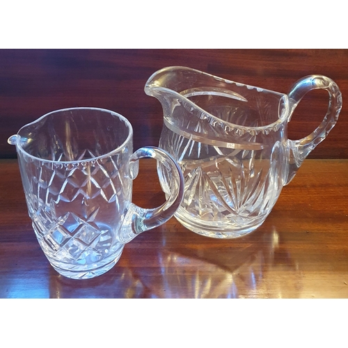 12 - A quantity of Waterford Crystal Glasses along with two jugs.