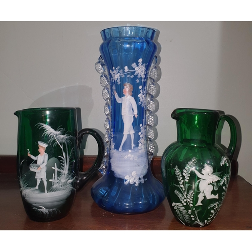 141 - Three Mary Gregory style Glass pieces to include two jugs and a vase. Vase H 28 cm approx.