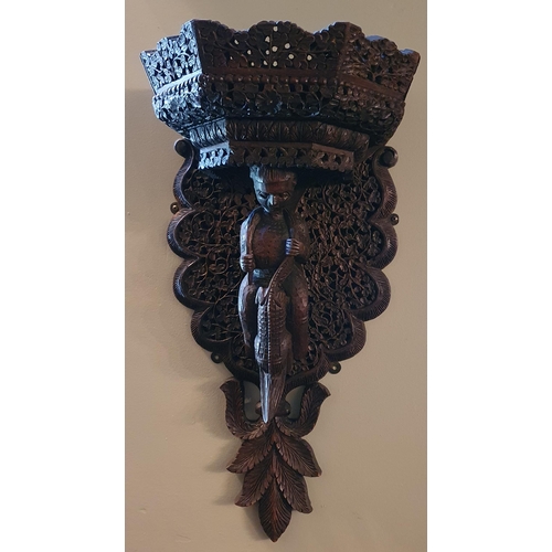 155 - A good 19th Century Padauk Wall Bracket with highly carved outline depicting a woman holding an alli... 