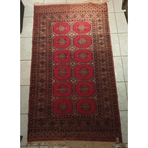 180 - A Persian Rug with multi borders and repeating medallion central design. 170 x 93 cm approx.