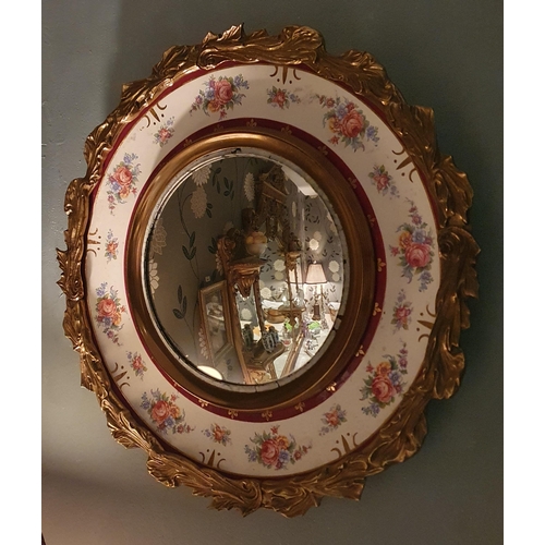 182 - A 20th Century circular Mirror with brass outline and transfer decorated and with ceramic centre.  D... 