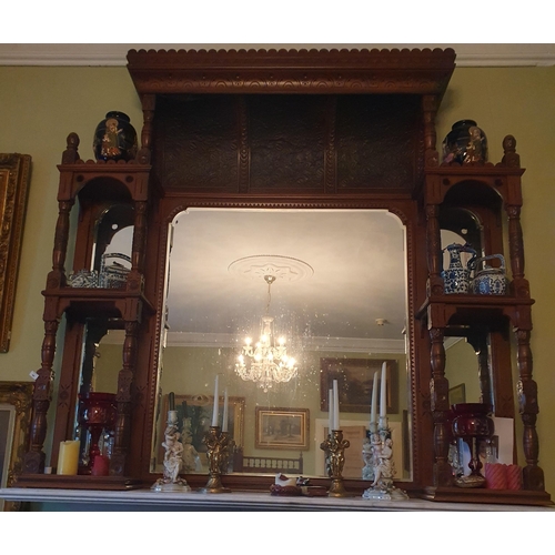 61 - A large late 19th Century Walnut Overmantel Mirror with architectural carved top and turned supports... 