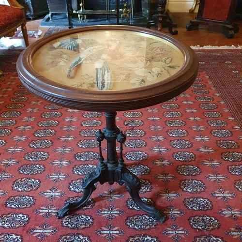 93 - A 19th Century circular Wine Table on a turned highly carved tripod support and with a tapestry glaz... 