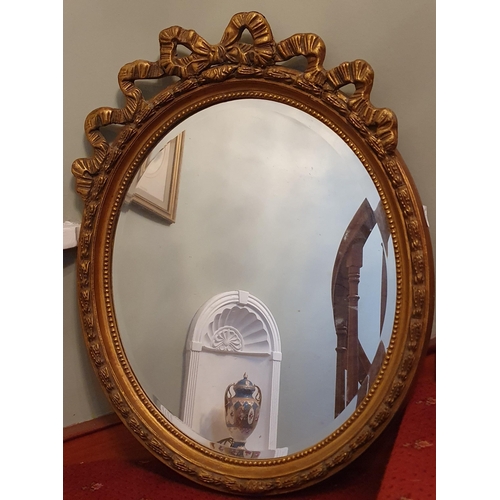 240 - A highly ornate oval plaster Mirror. 78 x 60 cm approx.