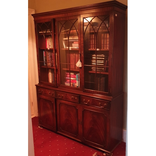 253 - A reproduction Mahogany and Veneered three door Bookcase with astragal glazed upper and triple friez... 