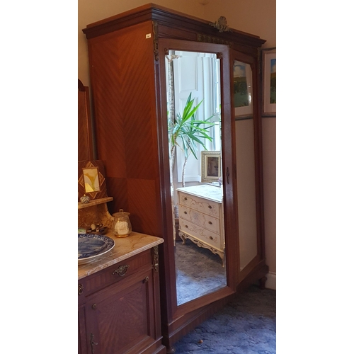 367 - A large 20th Century Mahogany two door Wardrobe with bevelled mirrored panel doors and ormolu mounts... 