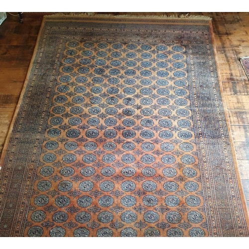 333 - A large rust ground Persian Carpet with multi borders and repeating medallion design. 195 x 305 cm a... 