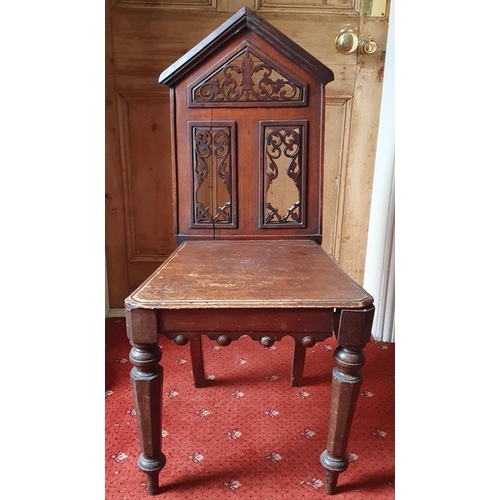 494 - A late 19th early 20th Century Walnut Hall Chair with pierced detail on turned octagonal supports.
W... 