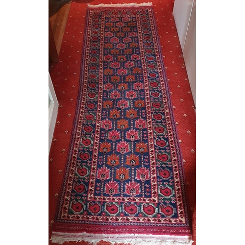 495 - A red ground Persian Runner with multi borders and unique repeating medallion design. 275 x 80 cm ap... 