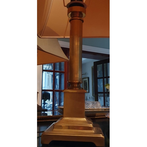 500 - A 20th Century Brass Table Lamp with shade on turned reeded columned support. H 40 cm approx.