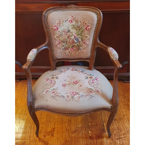 533 - A Continental Walnut showframe Armchair with tapestry style upholstery. W 59 x SH 41 x BH 85 cm appr... 