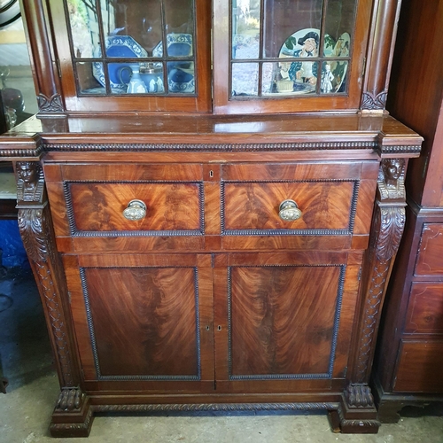 844 - A fine mahogany Secretaire Bookcase, in the Egyptian Revival style, the arched pediment with anthemi... 