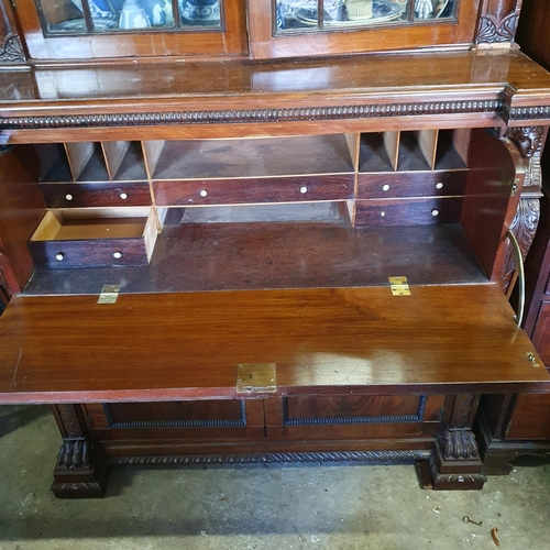 844 - A fine mahogany Secretaire Bookcase, in the Egyptian Revival style, the arched pediment with anthemi... 