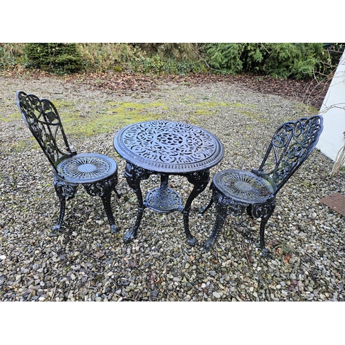 1041 - A Cast Iron circular Table Diam. 57 x H 65 cm approx. and a pair of Chairs with pierced outline.