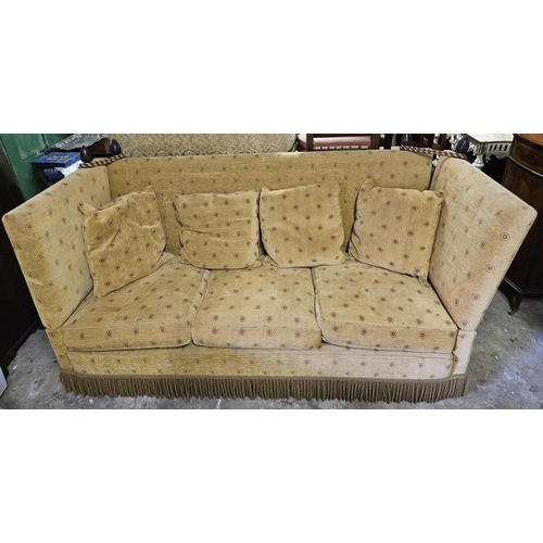 800 - A large Knole three seater Couch with fall flap arms and tiebacks. W 213 x D 80 x H 105 cm approx.