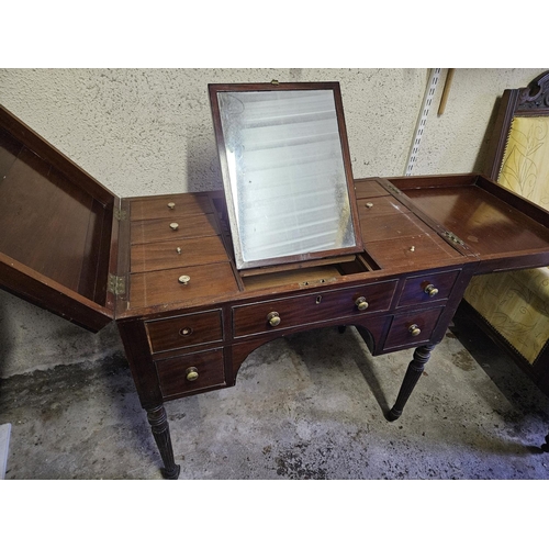 857 - A Georgian Mahogany Gentleman's Vanity Unit with lift up top, mirrored centre, on turned supports an... 