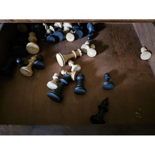 341 - A late 19th Century Walnut work Table with chessboard top along with a part set of timber chess piec... 