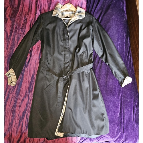 937 - A Black Burberry Coat, size Medium. 
Please note no condition reports will be done on this lot. We r... 