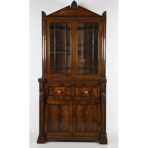 844 - A fine mahogany Secretaire Bookcase, in the Egyptian Revival style, the arched pediment with anthemi... 