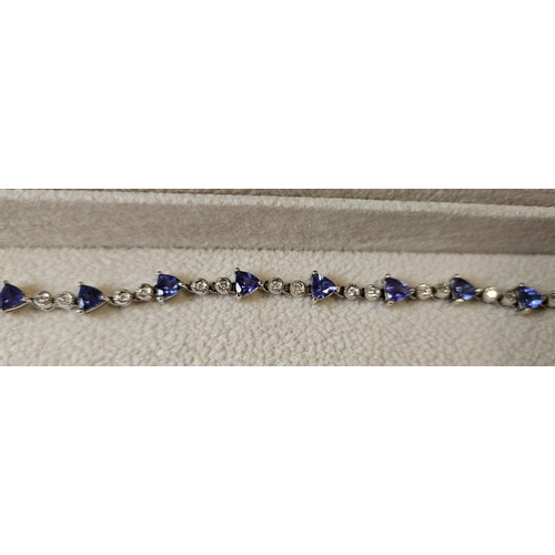 372 - An 18ct Gold, Diamond and Tanzanite Bracelet, with 30 brilliant cut Diamonds interspaced with Tanzan... 