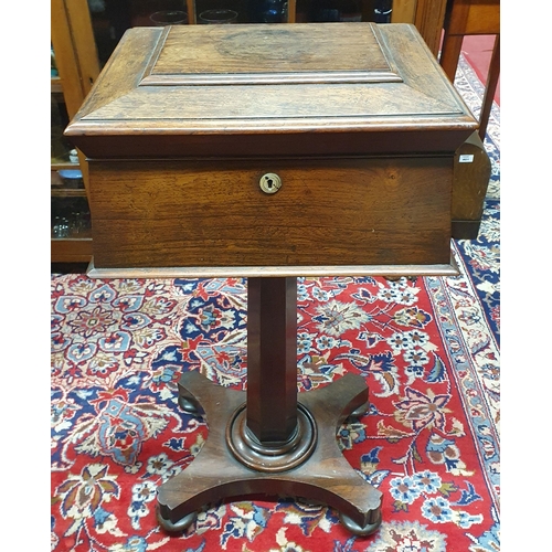 381 - A Regency Rosewood Teapoy of sarcophagus form with fitted interior on platform base. (lacking glass ... 