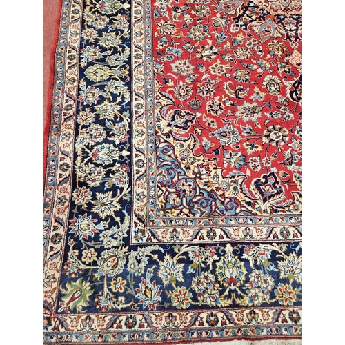 376 - A large Persian red ground Carpet with multi borders and central medallion design 390 x 297cm approx... 