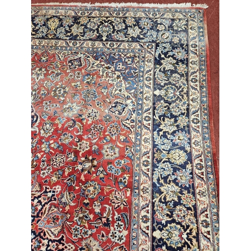 376 - A large Persian red ground Carpet with multi borders and central medallion design 390 x 297cm approx... 