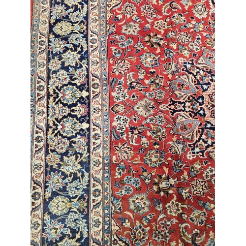 376 - A large Persian red ground Carpet with multi borders and central medallion design 390 x 297cm approx... 