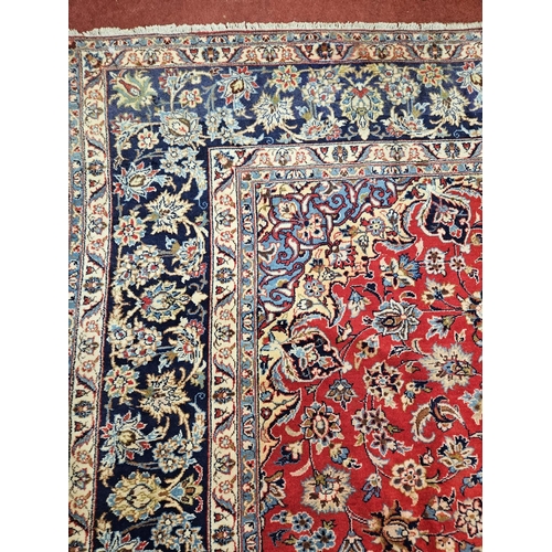 376 - A large Persian red ground Carpet with multi borders and central medallion design 390 x 297cm approx... 