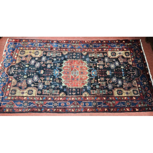 927 - A deep ground Persian Navan Carpet with a bespoke medallion design. 290 x 16 cm approx.