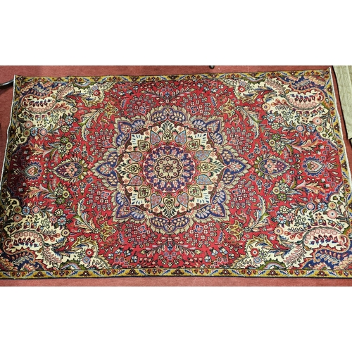 928 - A Red ground Persian Tabriz Carpet with a central lozenge medallion design and a multi coloured fiel... 