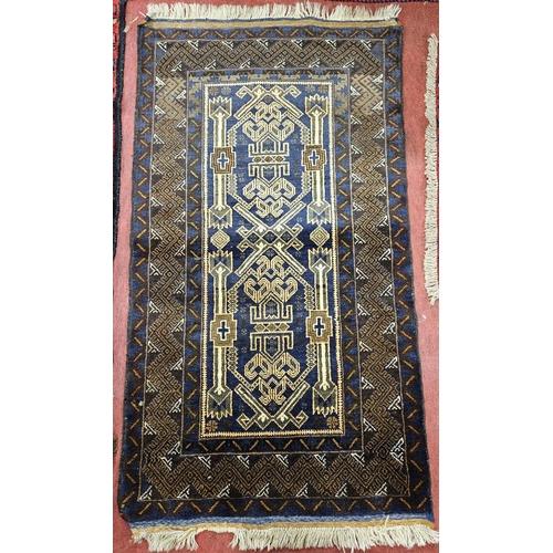 936 - A vintage Afghan Baluchi nomadic Blue ground Rug with all over design.