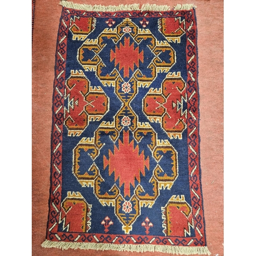 969 - A multi coloured hand woven nomadic Afghan Baluchi Rug. 137 x 84 cm approx.